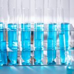Services Close-up of blue liquid in test tubes for chemistry experiments in a laboratory setting.
